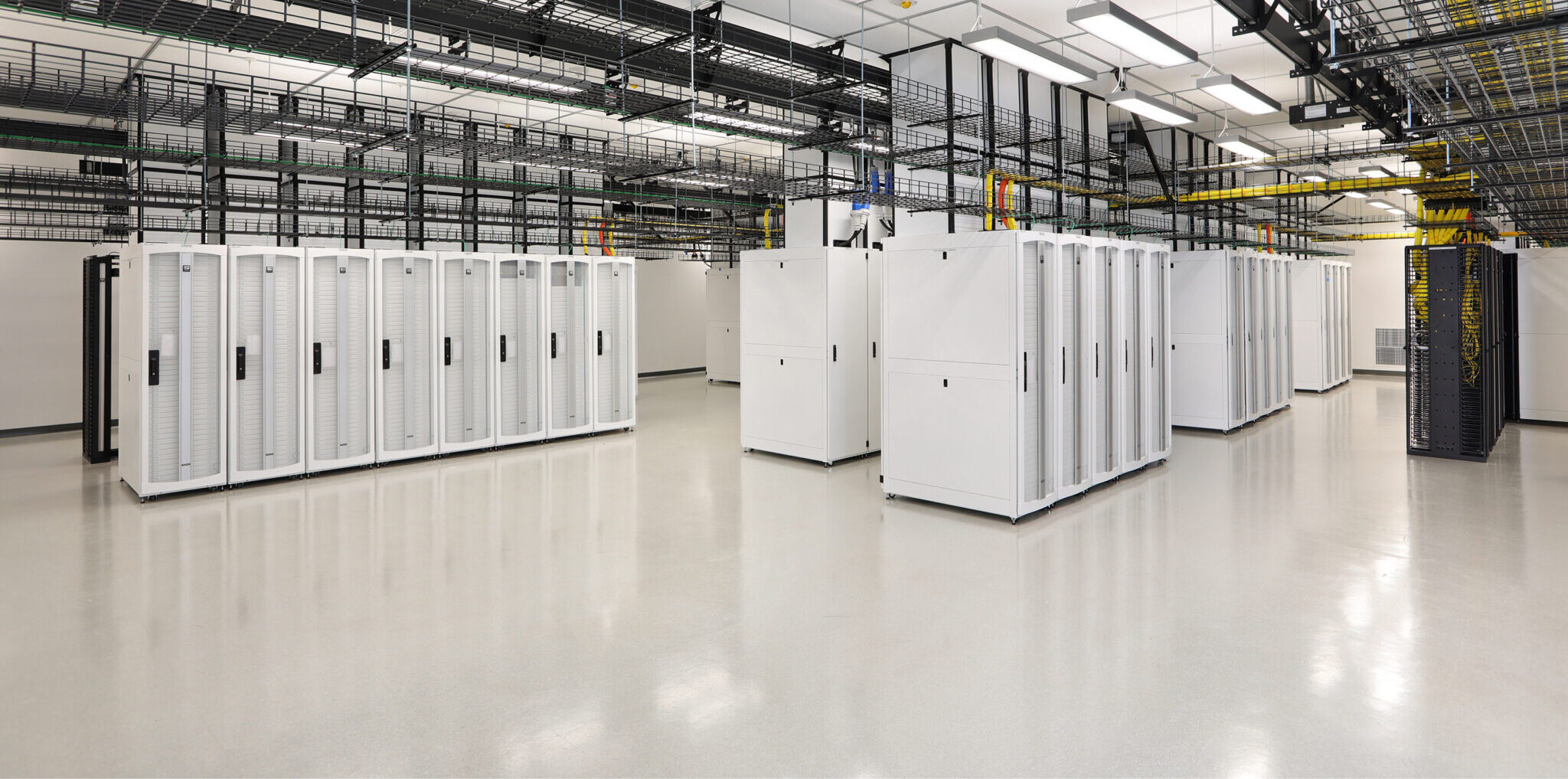 Large machines and technology sit in a white data center room
