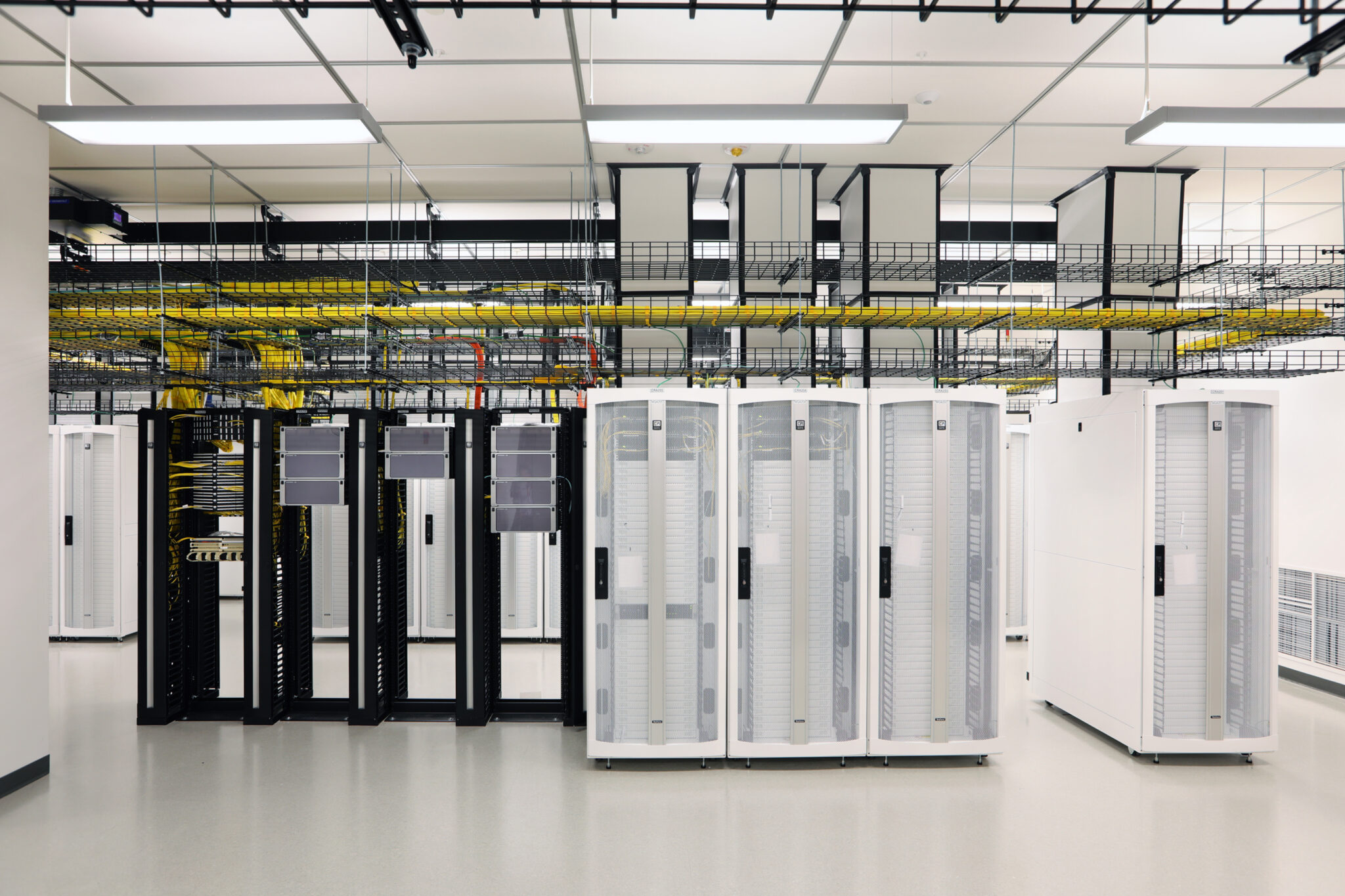 Large machines and technology sit in a white data center room