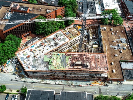 An aerial view of a crane in the courtyard of a building