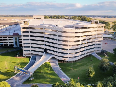 A 9 story parking deck with a rounded front wall.