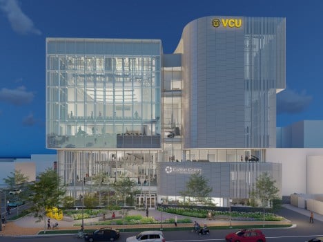 Image depicts a digital rendering of a large modern building constructed of steel and glass. The building has a large square glass portion on the left side.