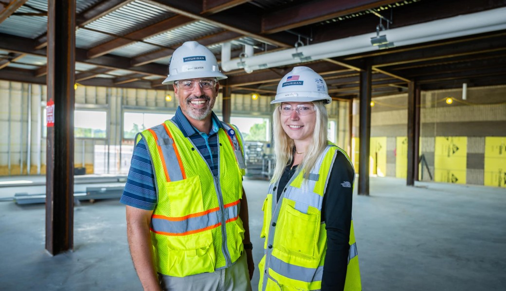 Women and man in construction safety gear on a construction site