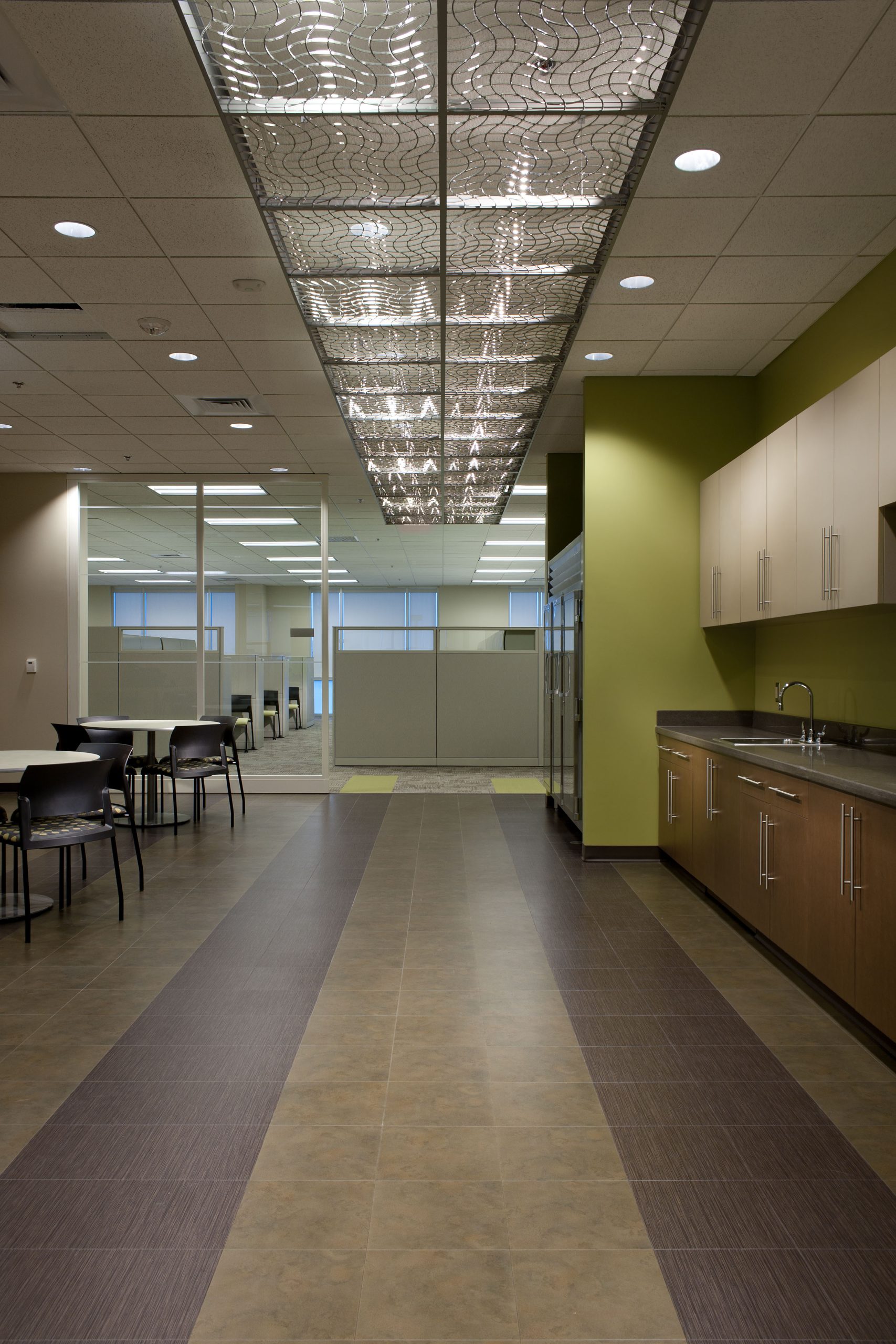 Interior of office with tables and chairs beside sideboard on right