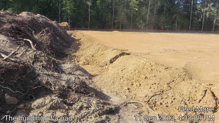 pile of dirt beside cleared pad