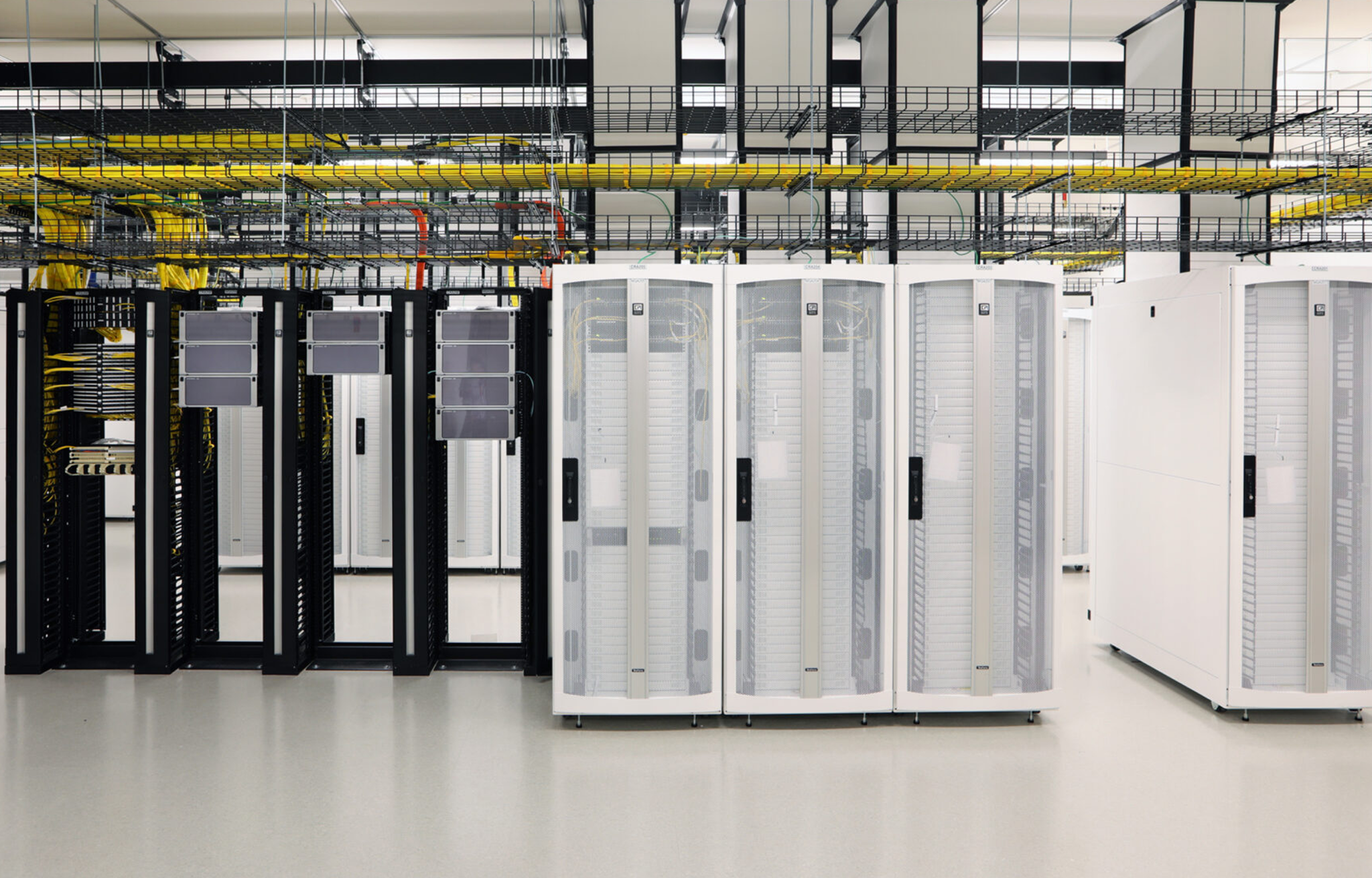Large machines and technology sit in a white data center room
